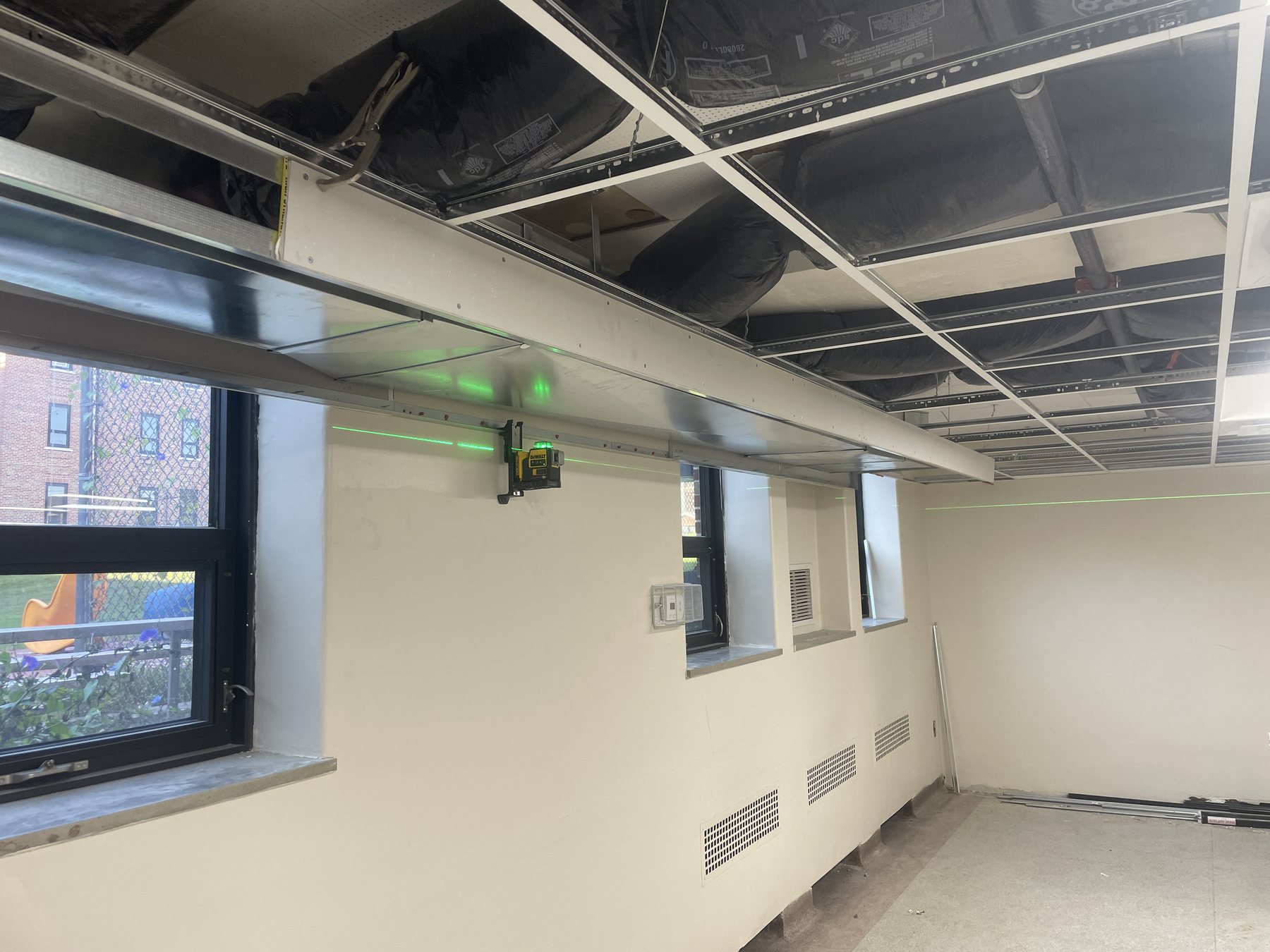 Ceiling layout lines and bulkhead framing coordinated during a commercial installation