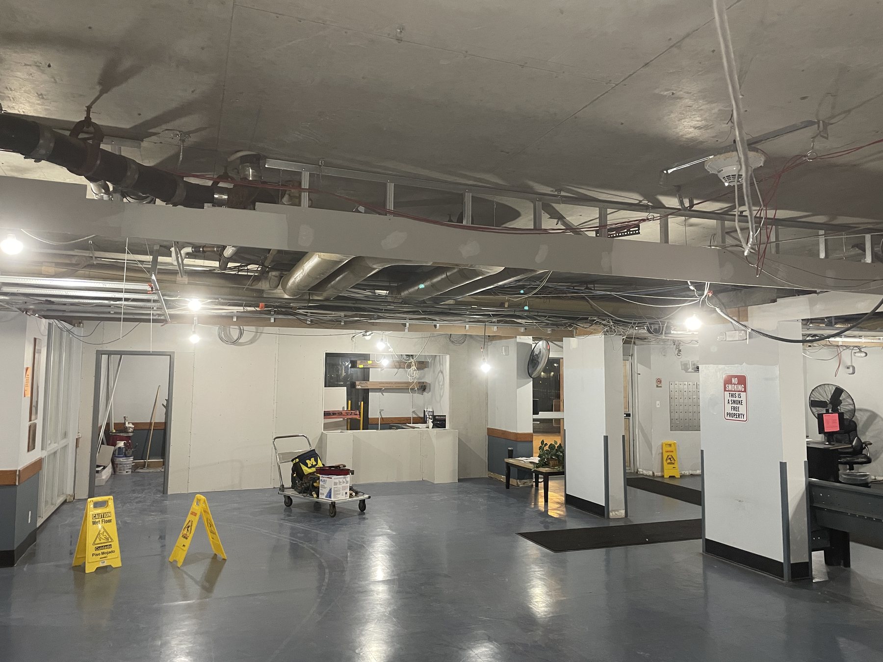 Commercial lobby with open overhead structure before ceiling installation