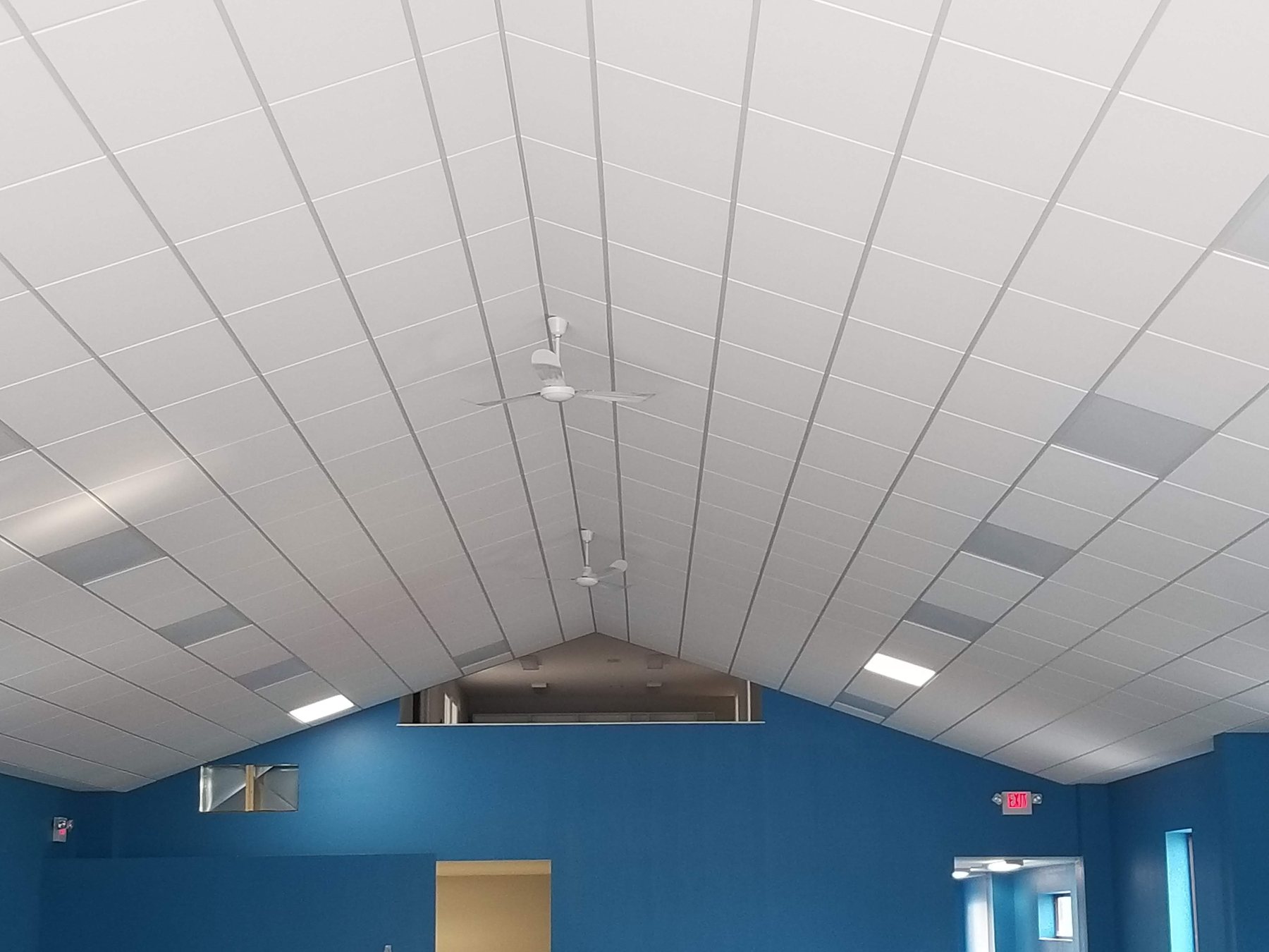 Completed vaulted acoustical ceiling across a large commercial interior