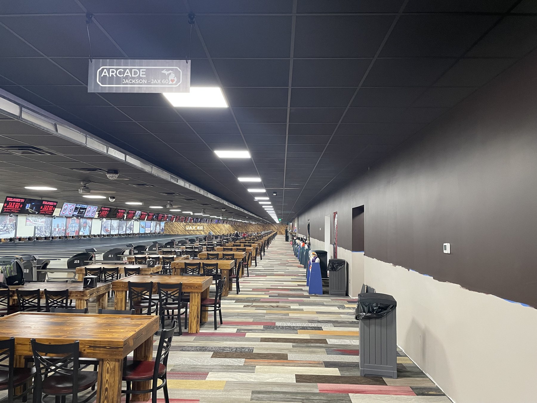 Completed dark acoustical suspension system across a large commercial interior